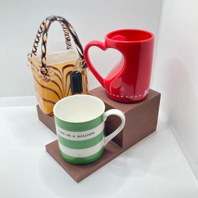 LOT 178: Lenox Kate Spade One In A Million Mug, Art Glass Animal Print Handbag Vase, Leather Coach Hang Tag and Krispy Kreme Mug