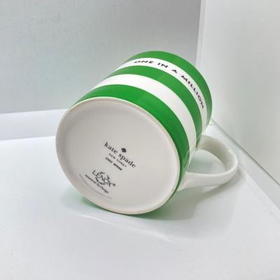 LOT 178: Lenox Kate Spade One In A Million Mug, Art Glass Animal Print Handbag Vase, Leather Coach Hang Tag and Krispy Kreme Mug