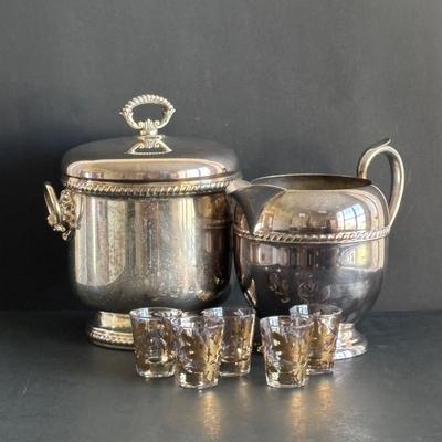 LOT 92: Sheffield Silve Plated Ice Bucket w/Lion Handles, Etched Pink Depressio Glasses (2), Etched Pilsner Glasses (3), MCM Gold Oak...