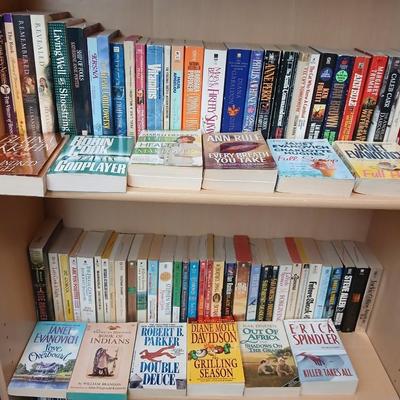 Two shelves of paperback books - Janet Evanovich - Eric Spindler - Ken Follett - and many other Authors - Great reads!