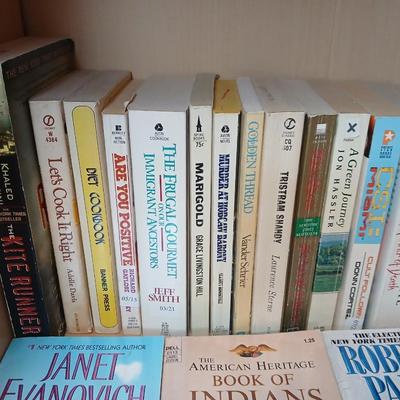 Two shelves of paperback books - Janet Evanovich - Eric Spindler - Ken Follett - and many other Authors - Great reads!