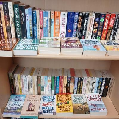 Two shelves of paperback books - Janet Evanovich - Eric Spindler - Ken Follett - and many other Authors - Great reads!