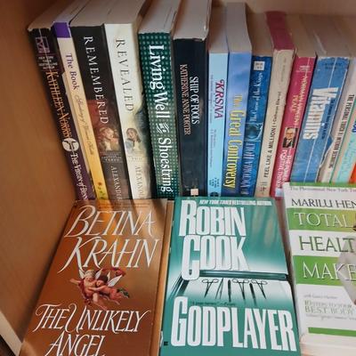 Two shelves of paperback books - Janet Evanovich - Eric Spindler - Ken Follett - and many other Authors - Great reads!
