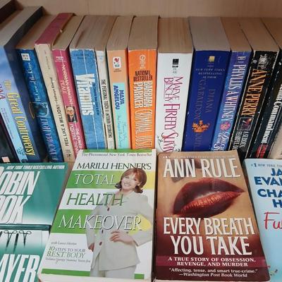 Two shelves of paperback books - Janet Evanovich - Eric Spindler - Ken Follett - and many other Authors - Great reads!