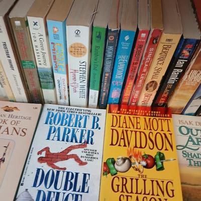 Two shelves of paperback books - Janet Evanovich - Eric Spindler - Ken Follett - and many other Authors - Great reads!