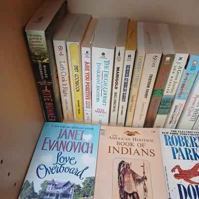 Two shelves of paperback books - Janet Evanovich - Eric Spindler - Ken Follett - and many other Authors - Great reads!