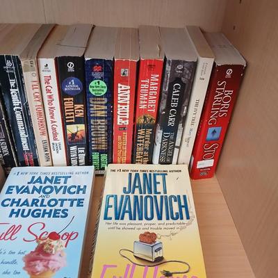 Two shelves of paperback books - Janet Evanovich - Eric Spindler - Ken Follett - and many other Authors - Great reads!