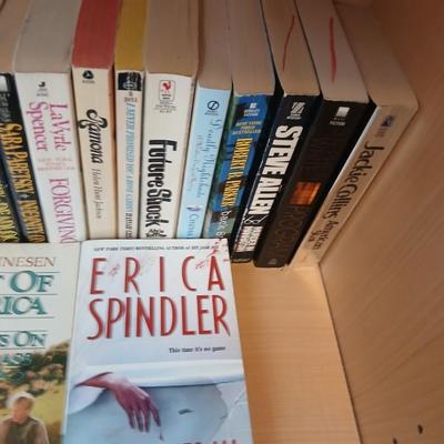 Two shelves of paperback books - Janet Evanovich - Eric Spindler - Ken Follett - and many other Authors - Great reads!