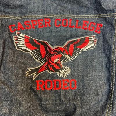 Sale Photo Thumbnail #615: This stylish denim jacket features Casper College Rodeo embroidery and a durable design, ideal for casual or western wear.

• Button-Up Front Closure
• Dual Chest Pockets With Button Flap
• Side Welt Pockets
• Embroidered Casper College Rodeo Logo