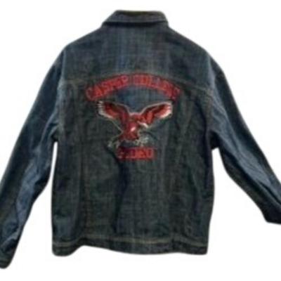 Sale Photo Thumbnail #619: This stylish denim jacket features Casper College Rodeo embroidery and a durable design, ideal for casual or western wear.

• Button-Up Front Closure
• Dual Chest Pockets With Button Flap
• Side Welt Pockets
• Embroidered Casper College Rodeo Logo