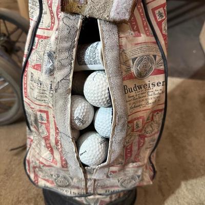 SET OF GOLF CLUBS, BUDWEISER BAG, GOLF BALLS AND DOLLY