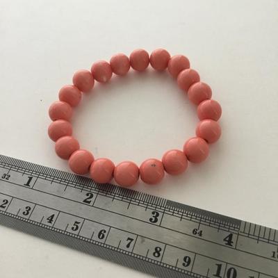 Coral colored beaded stretchy fashion bracelet