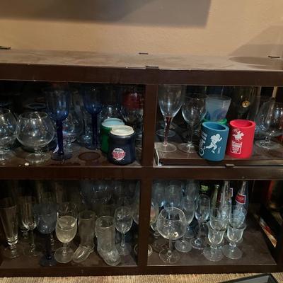 Plastic storage shelves full of clear wine glasses