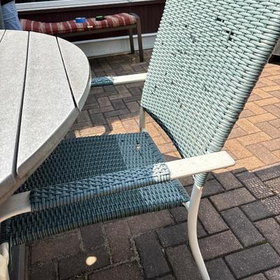 Composite patio table, umbrella with stand and three chairs