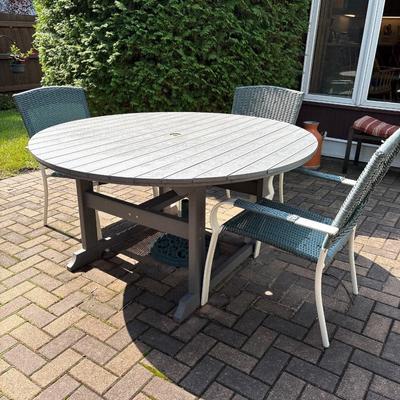 Composite patio table, umbrella with stand and three chairs