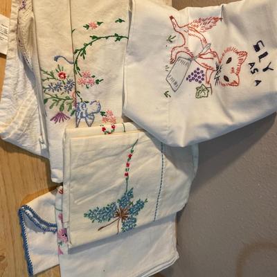 Embroidered pillowcases, table, runners, and holder