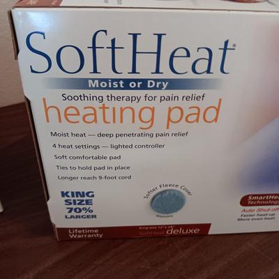 NEW NORELCO SHAVER, KING SIZE HEATING PAD AND A SCRUBBER