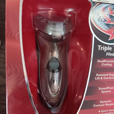 NEW NORELCO SHAVER, KING SIZE HEATING PAD AND A SCRUBBER