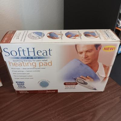 NEW NORELCO SHAVER, KING SIZE HEATING PAD AND A SCRUBBER
