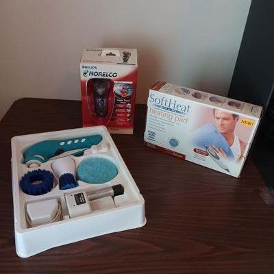NEW NORELCO SHAVER, KING SIZE HEATING PAD AND A SCRUBBER