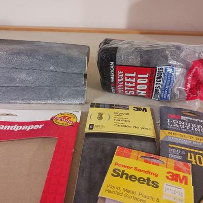 LONG DRILL BITS, VARIETY OF SANDPAPER AND AN INTERIOR DESIGN BOOK
