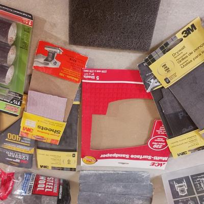 LONG DRILL BITS, VARIETY OF SANDPAPER AND AN INTERIOR DESIGN BOOK