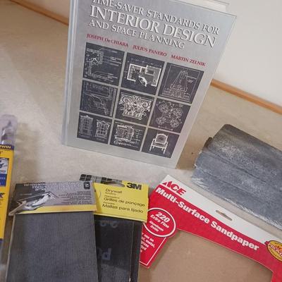 LONG DRILL BITS, VARIETY OF SANDPAPER AND AN INTERIOR DESIGN BOOK