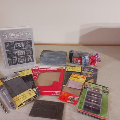 LONG DRILL BITS, VARIETY OF SANDPAPER AND AN INTERIOR DESIGN BOOK