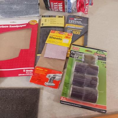 LONG DRILL BITS, VARIETY OF SANDPAPER AND AN INTERIOR DESIGN BOOK