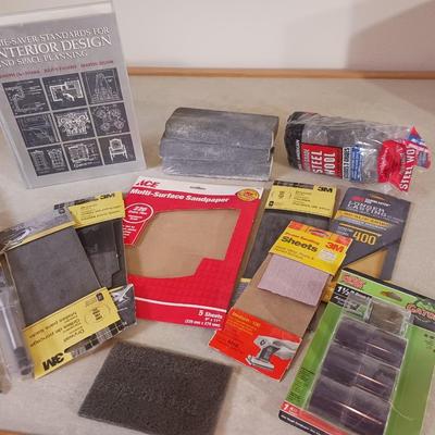 LONG DRILL BITS, VARIETY OF SANDPAPER AND AN INTERIOR DESIGN BOOK