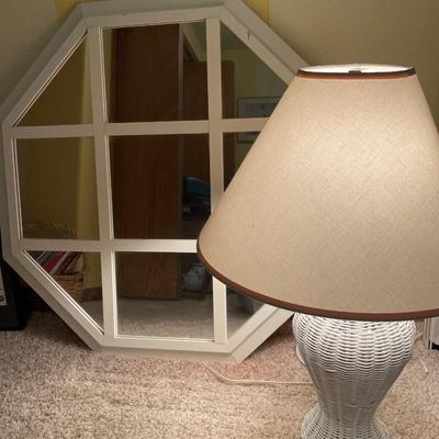 White frame mirror and wicker lamp