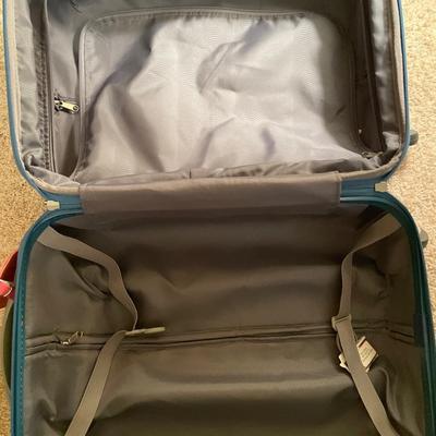 Small hard sided carryon suitcase and rack