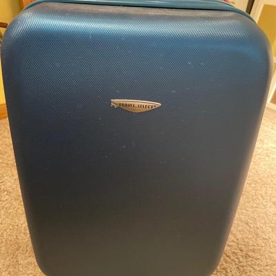 Small hard sided carryon suitcase and rack