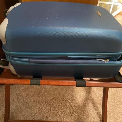 Small hard sided carryon suitcase and rack