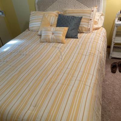 Sunny yellow comforter and white wicker headboard with mattress