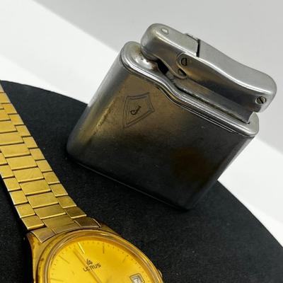 LOT: 106J: Junk Drawer Lot: Lorus Men's Watch (Not Working), Pocket Knives, Vintage Colibri Lighter and 1914 British Penny