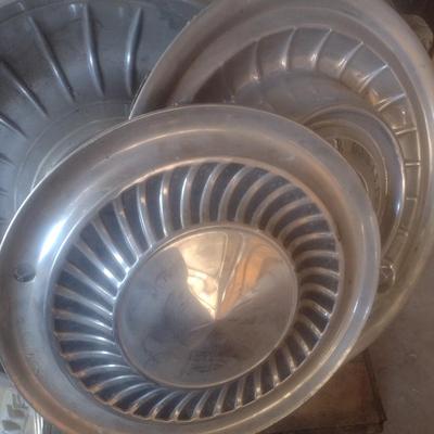 Collection of Vintage Automobile Hubcaps Includes Ford, Cadillac, VW, Others
