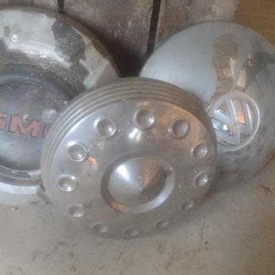 Collection of Vintage Automobile Hubcaps Includes Ford, Cadillac, VW, Others