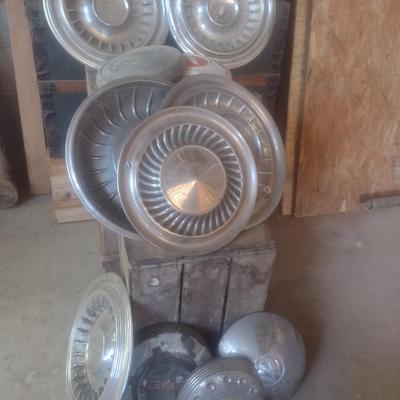 Collection of Vintage Automobile Hubcaps Includes Ford, Cadillac, VW, Others