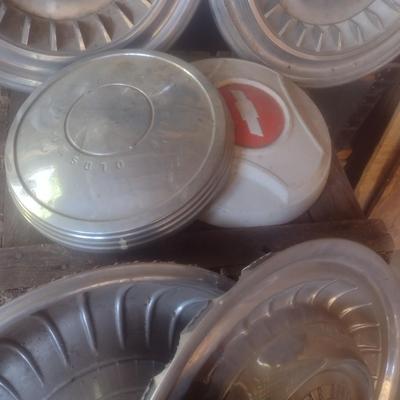 Collection of Vintage Automobile Hubcaps Includes Ford, Cadillac, VW, Others