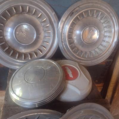 Collection of Vintage Automobile Hubcaps Includes Ford, Cadillac, VW, Others