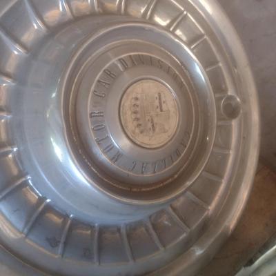 Collection of Vintage Automobile Hubcaps Includes Ford, Cadillac, VW, Others
