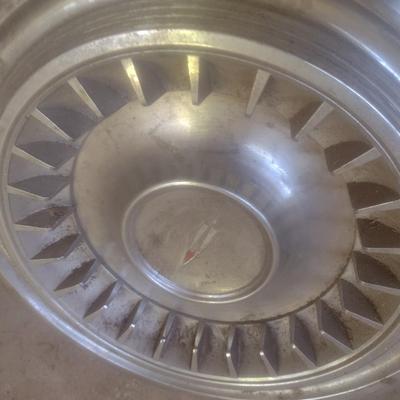 Collection of Vintage Automobile Hubcaps Includes Ford, Cadillac, VW, Others