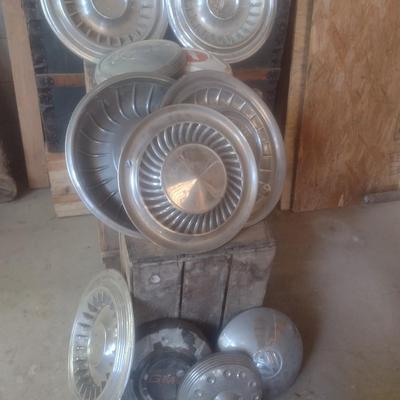Collection of Vintage Automobile Hubcaps Includes Ford, Cadillac, VW, Others