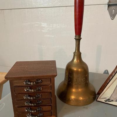 Tall brass bell with misc decor