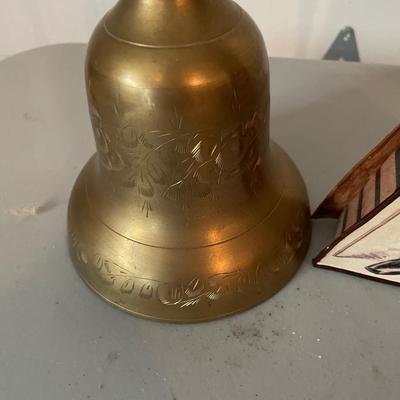 Tall brass bell with misc decor