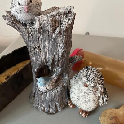 Two outdoor birds, bird feeder, rocks and wood