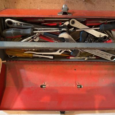 Red metal toolbox with tools