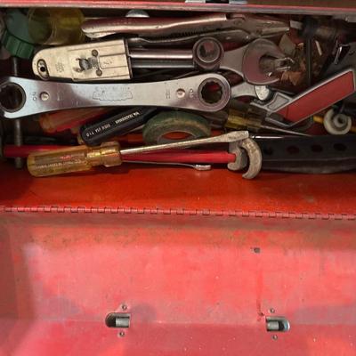 Red metal toolbox with tools