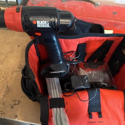 Black & Decker drill with bits and red bag